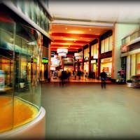 Explore the lively atmosphere of a modern shopping mall in Hoofddorp, Netherlands, captured with vibrant colors and motion blur.